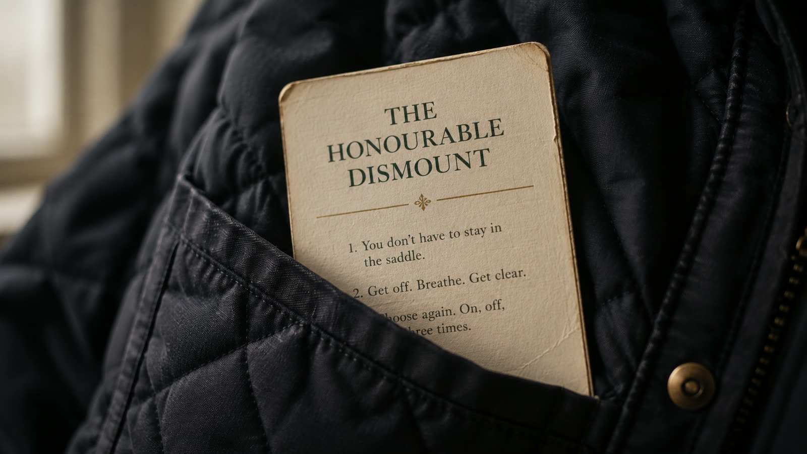 The Honourable Dismount card in the pocket of a quilted riding jacket.